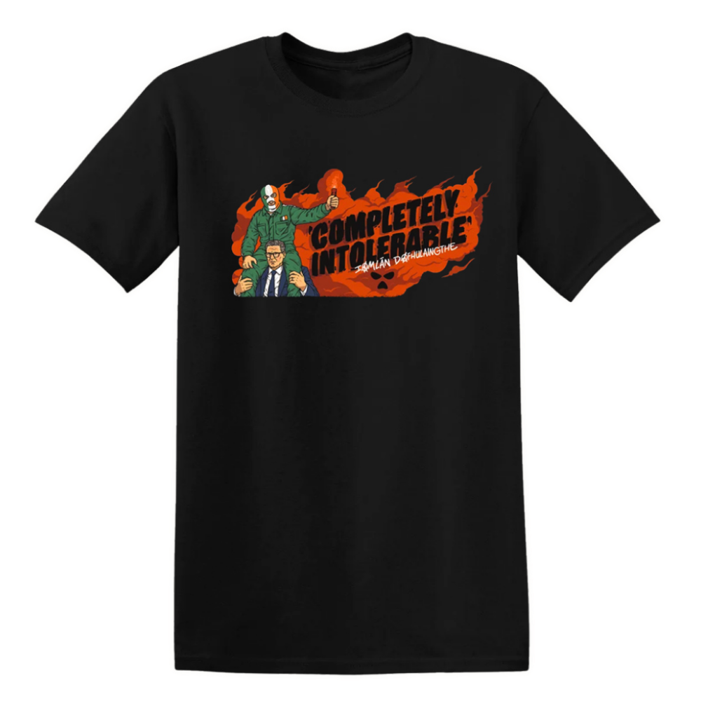 A black short-sleeve crewneck t-shirt featuring a graphic print of the 'Completely Intolerable' image of Kneecap. The graphic shows the character in a green suit alongside a man in a suit, set against a background of orange flames and bold black text.